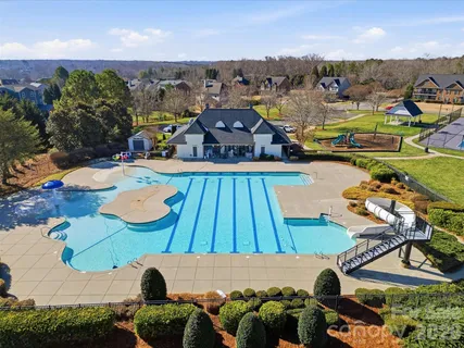 an aerial view of a house with yard swimming pool and outdoor seating