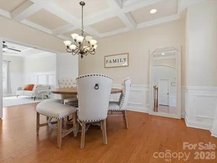 a view of a dining room with furniture and a chandelier