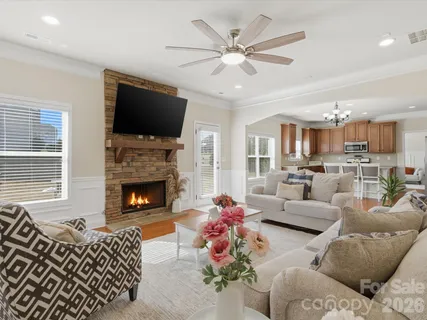 a living room with furniture fireplace and a flat screen tv