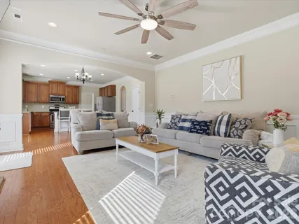 a living room with furniture and a chandelier