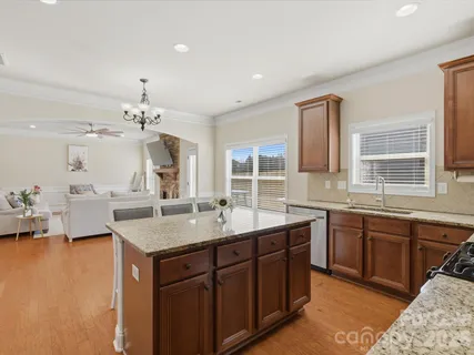 a kitchen with sink and view of living room