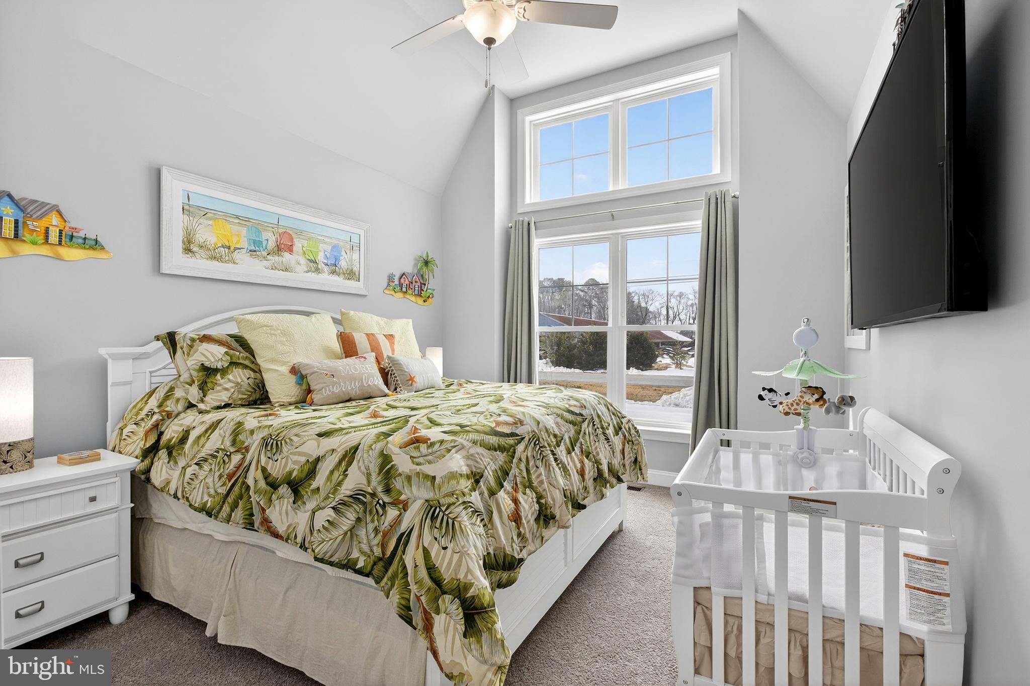 32143 Lynch Road Selbyville, DE 19975 - Photo 11 of 56 a bed sitting in a bedroom next to a window
