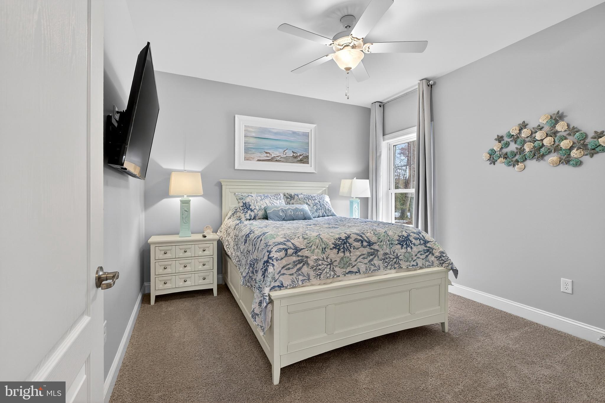 32143 Lynch Road Selbyville, DE 19975 - Photo 12 of 56 a bedroom with a bed and a painting on the wall
