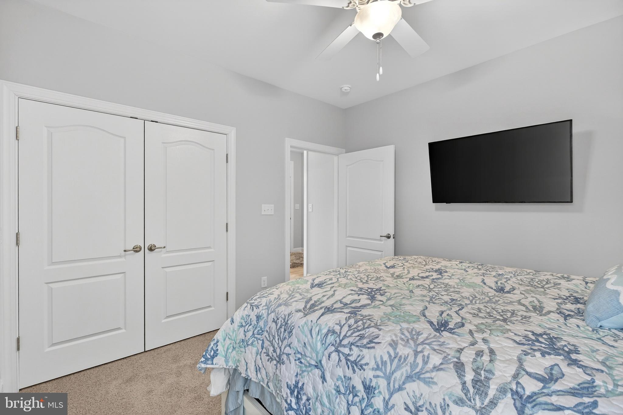 32143 Lynch Road Selbyville, DE 19975 - Photo 13 of 56 a bedroom with a bed and a flat screen tv