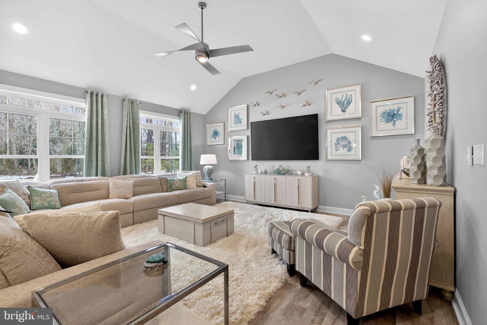 32143 Lynch Road Selbyville, DE 19975 - Photo 15 of 56 a living room with furniture and a flat screen tv