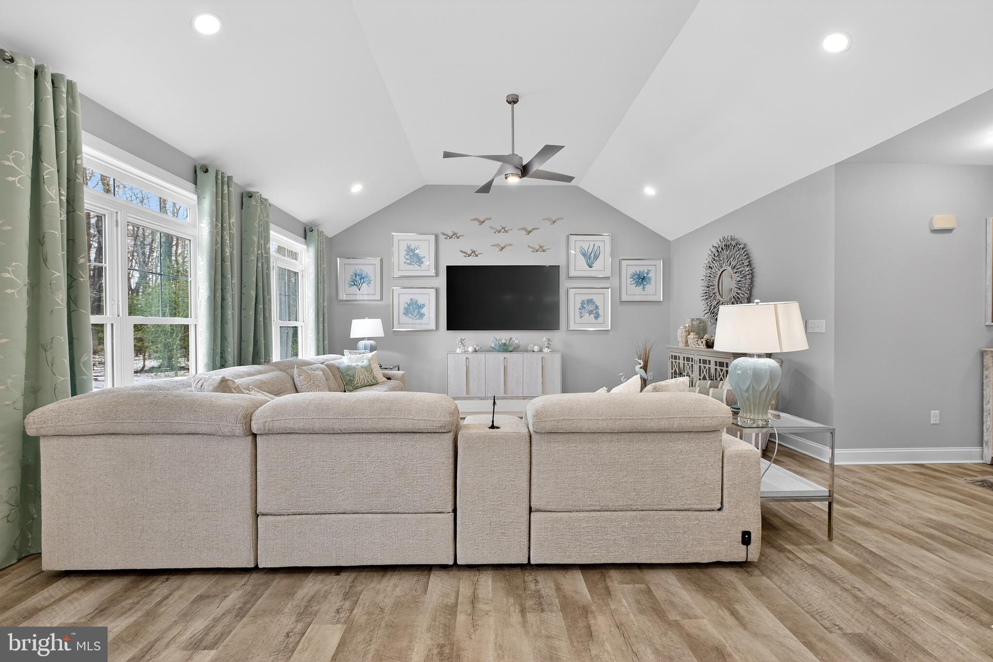 32143 Lynch Road Selbyville, DE 19975 - Photo 18 of 56 a living room with furniture a flat screen tv and a fireplace
