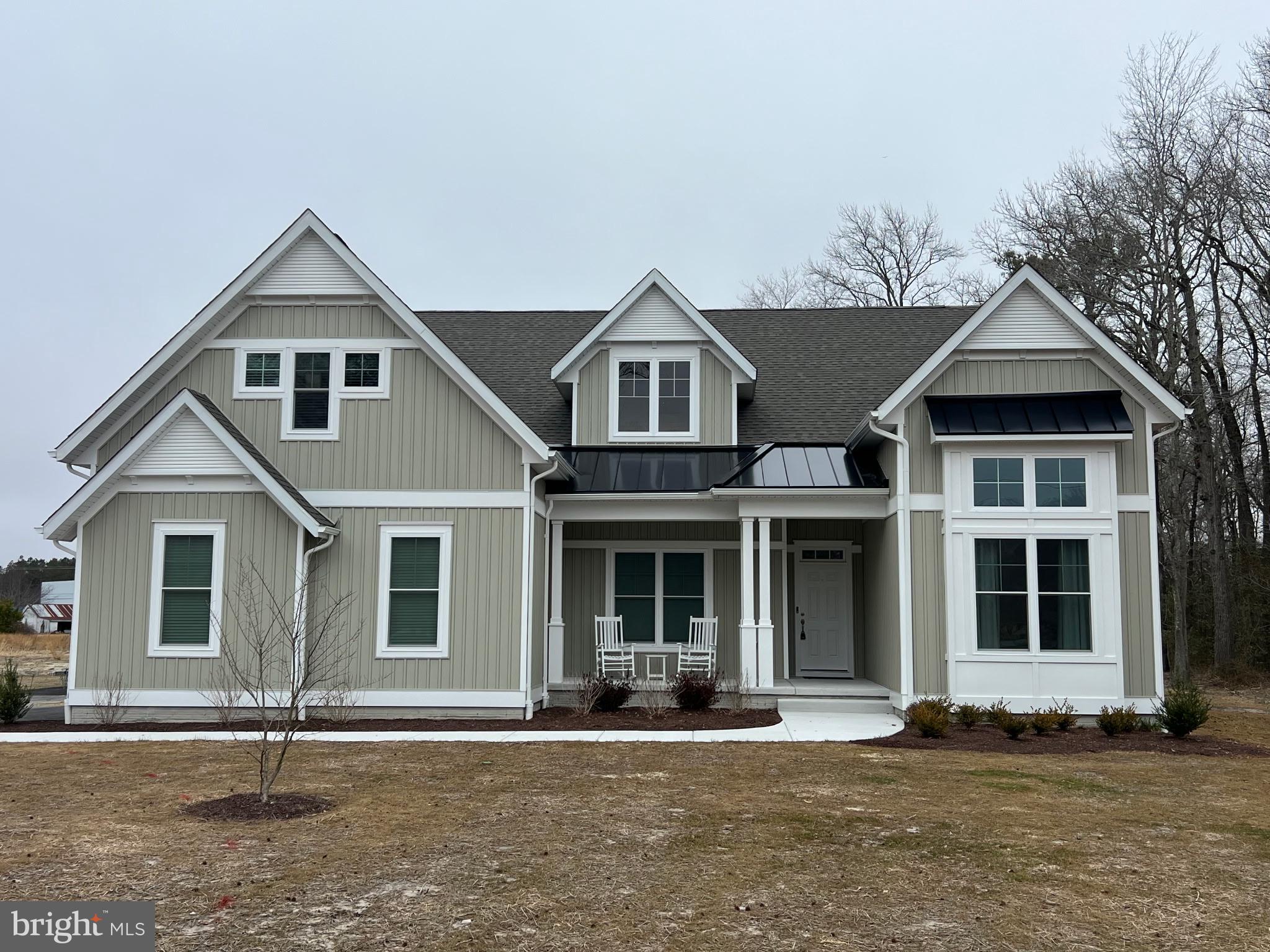 32143 Lynch Road Selbyville, DE 19975 - Photo 2 of 56 a front view of a house with a yard