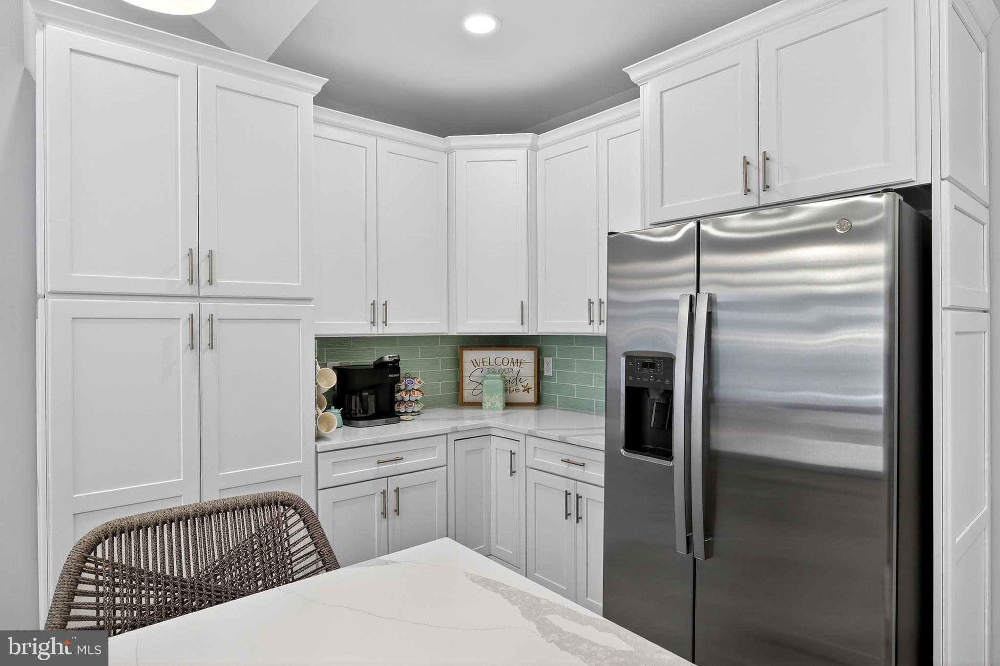 32143 Lynch Road Selbyville, DE 19975 - Photo 27 of 56 a kitchen with white cabinets and refrigerator