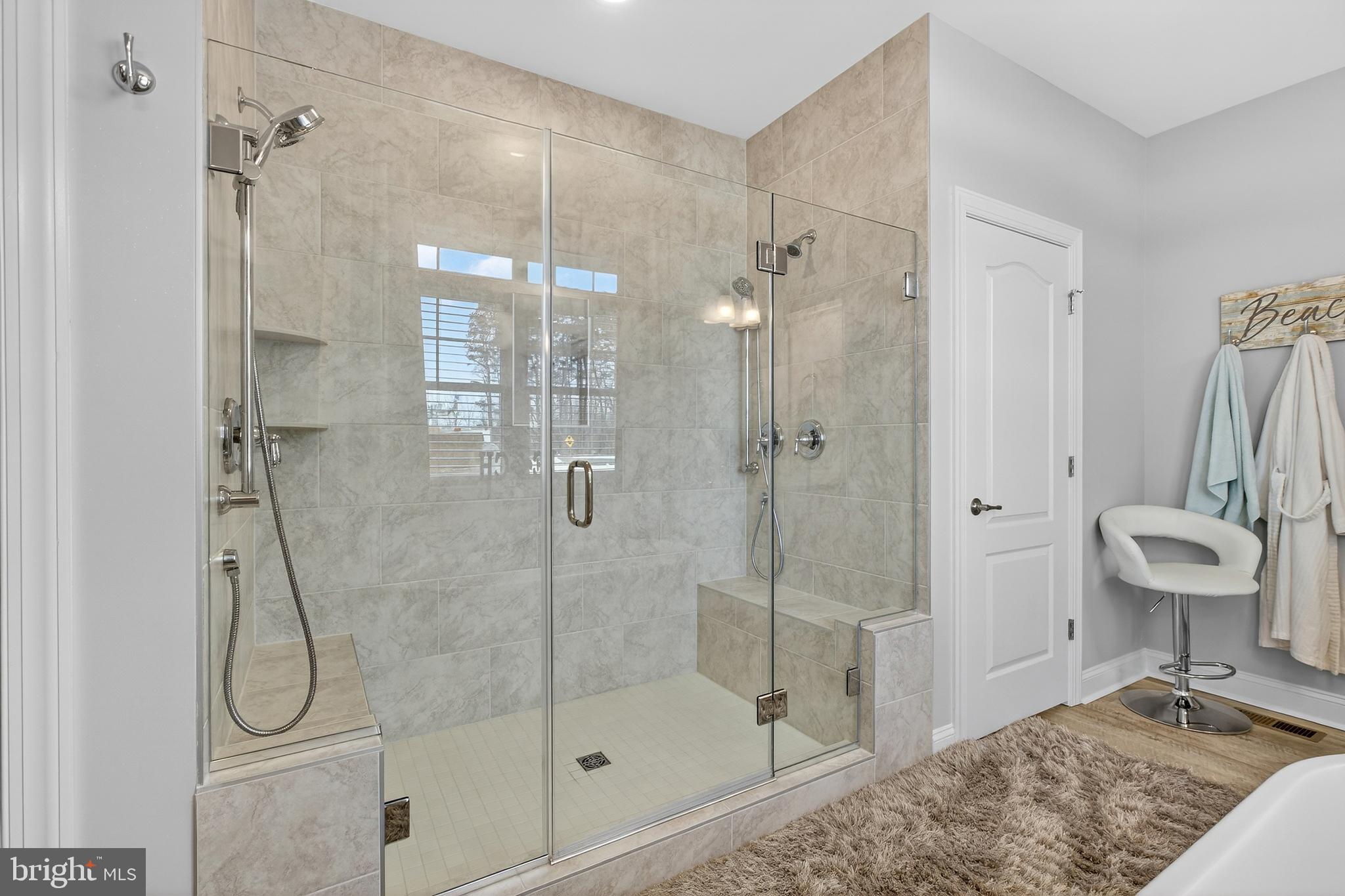 32143 Lynch Road Selbyville, DE 19975 - Photo 34 of 56 a bathroom with a shower bathtub mirror and toilet