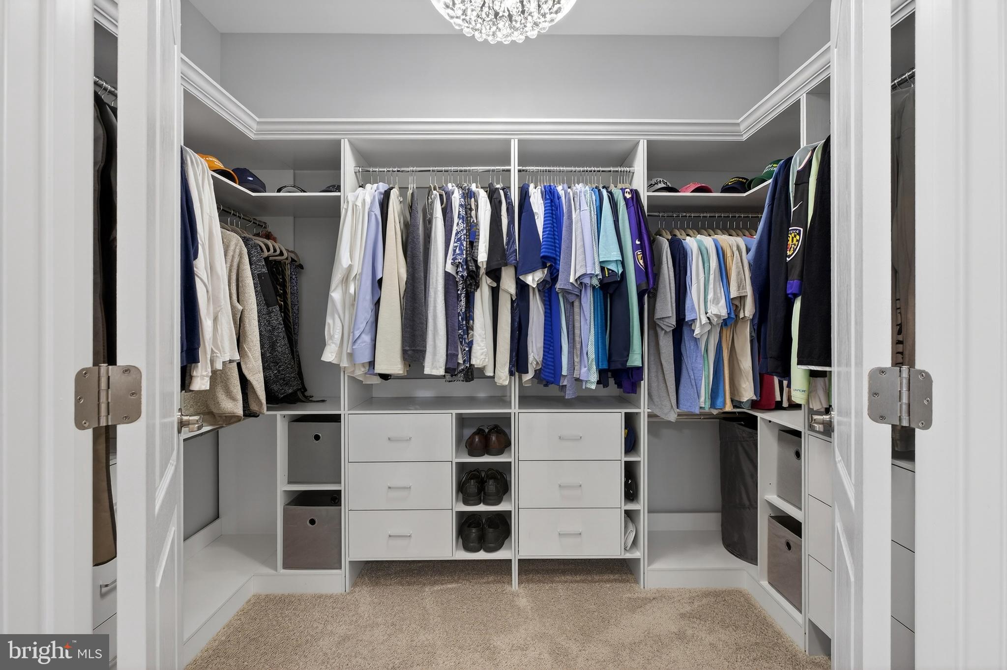 32143 Lynch Road Selbyville, DE 19975 - Photo 36 of 56 a view of walk in closet with clothes and shoes
