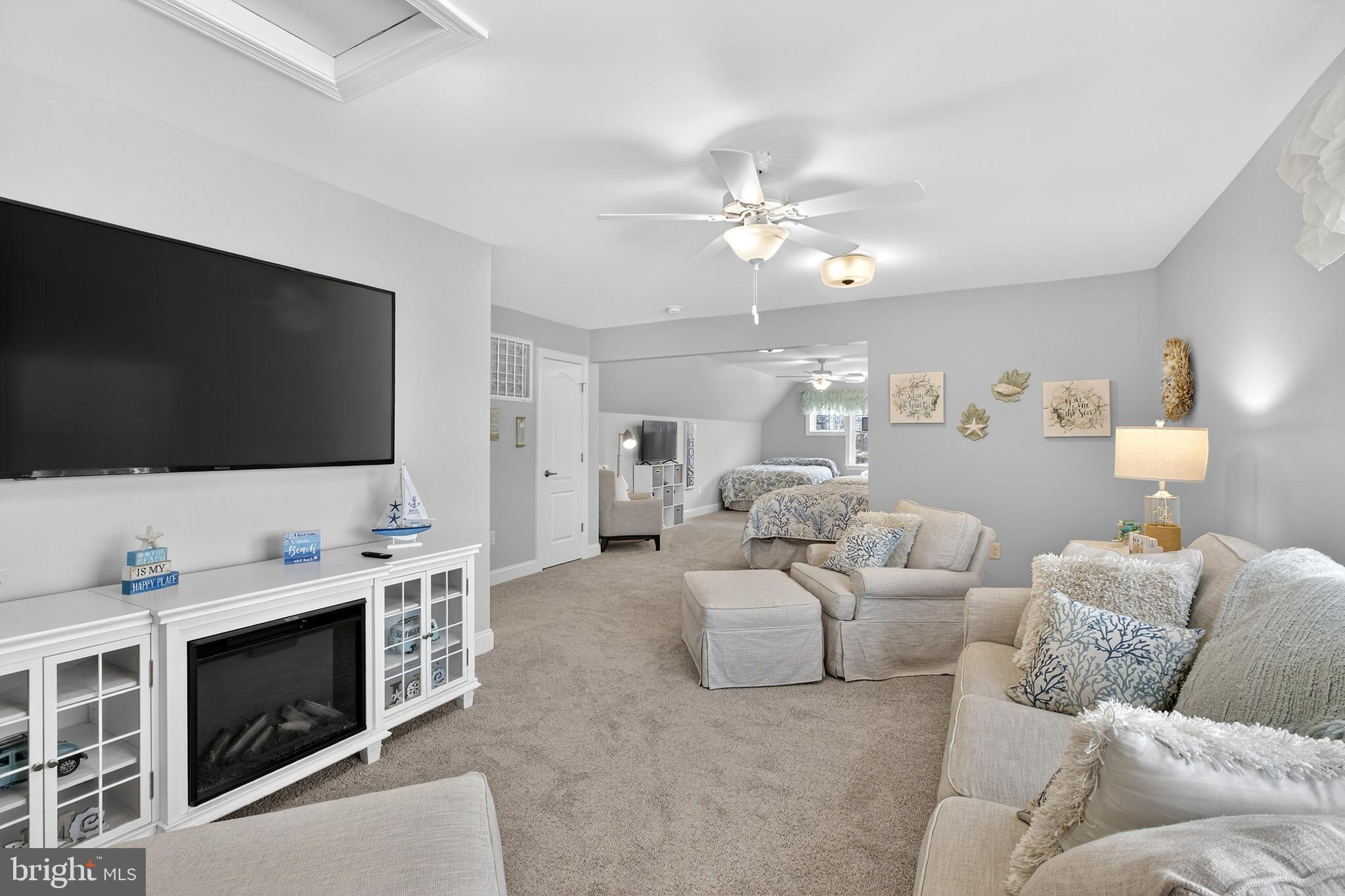 32143 Lynch Road Selbyville, DE 19975 - Photo 39 of 56 a living room with furniture and a flat screen tv