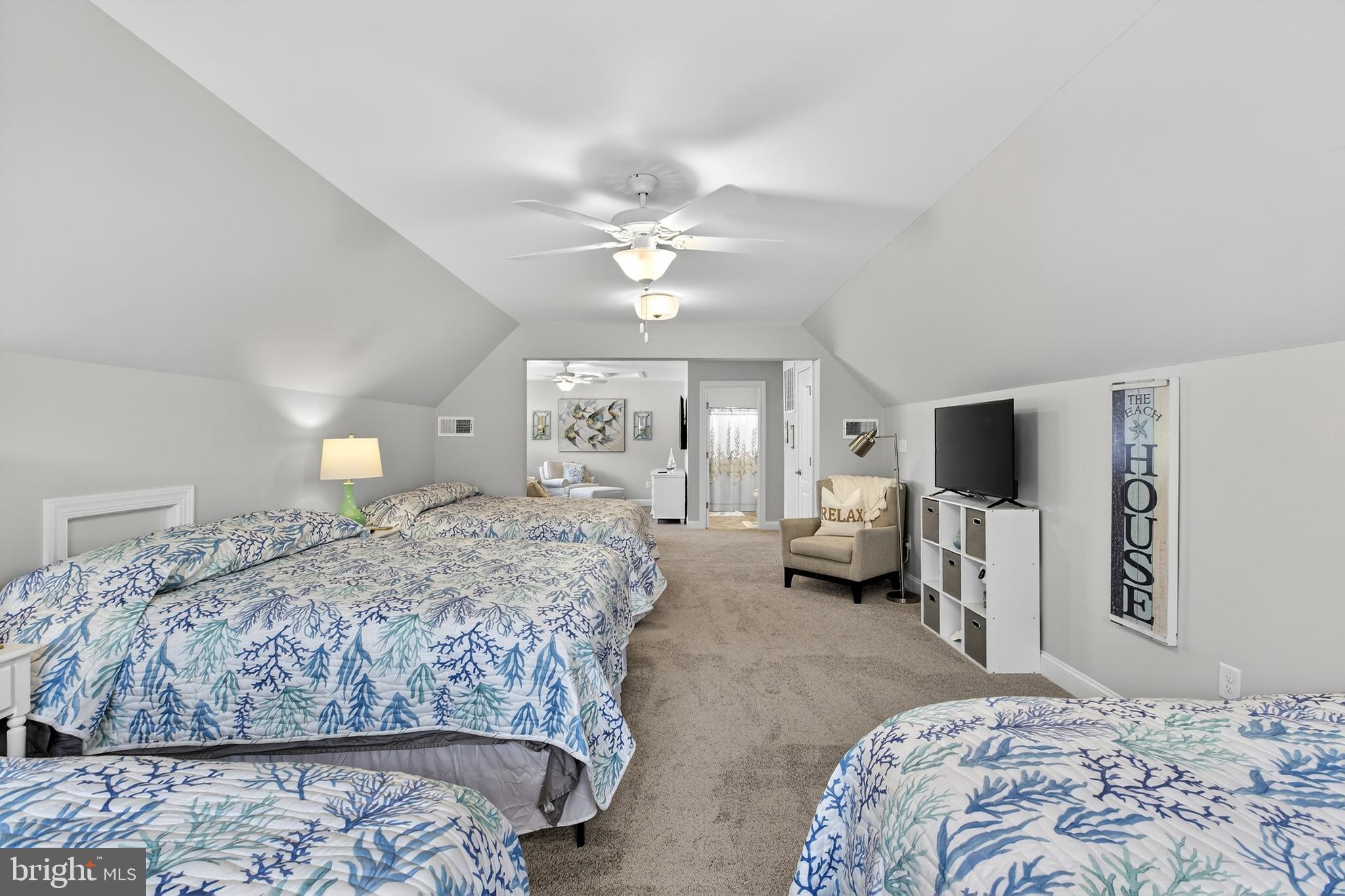 32143 Lynch Road Selbyville, DE 19975 - Photo 44 of 56 a bedroom with a large bed and a chandelier