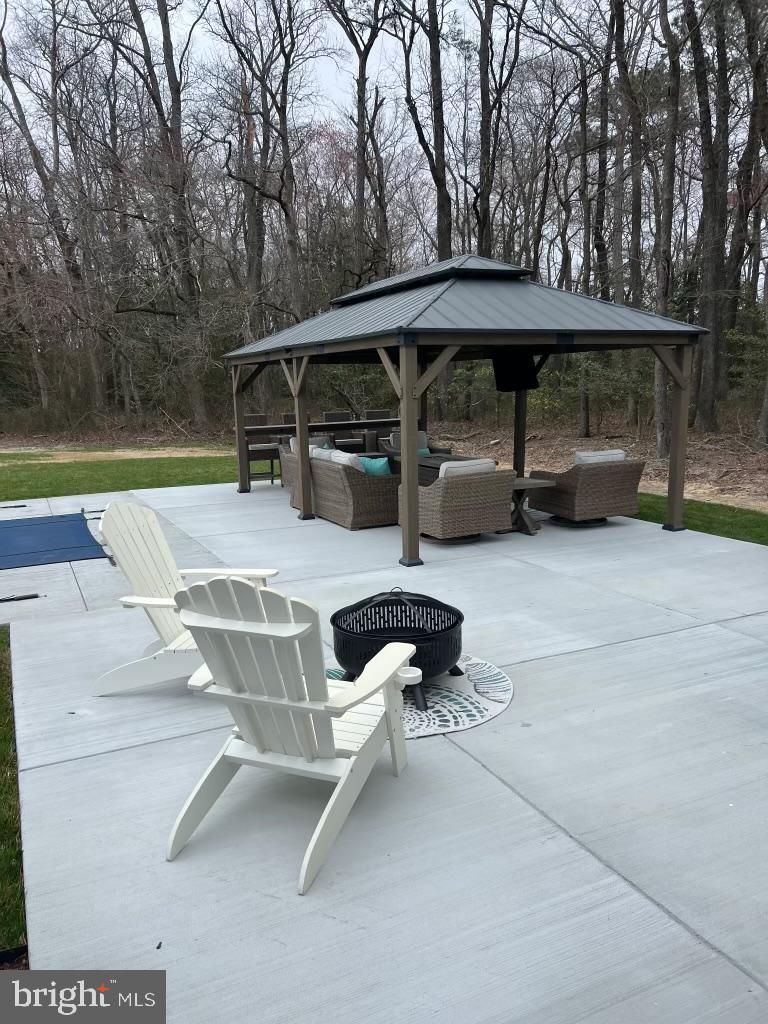32143 Lynch Road Selbyville, DE 19975 - Photo 48 of 56 a view of backyard with swimming pool and sitting area