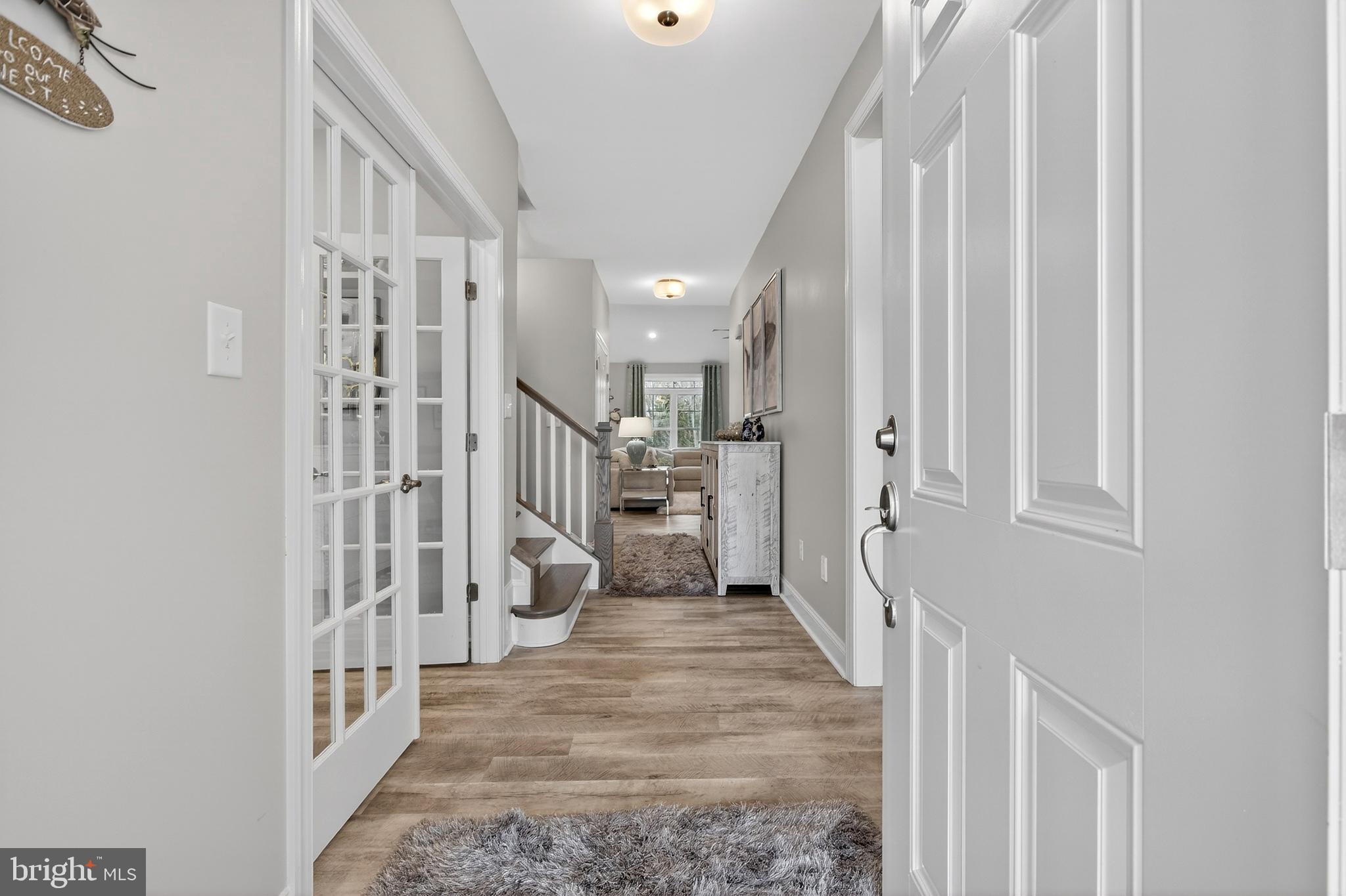 32143 Lynch Road Selbyville, DE 19975 - Photo 5 of 56 a view of a hallway with wooden floor and staircase