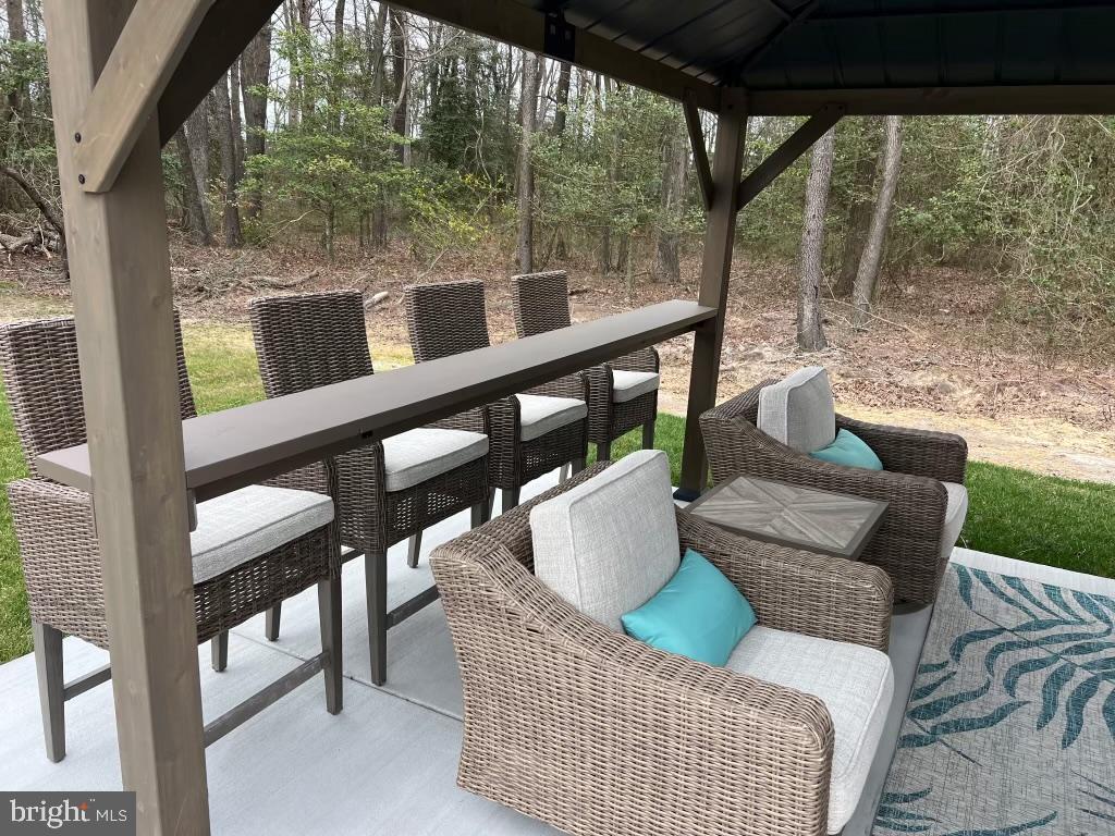 32143 Lynch Road Selbyville, DE 19975 - Photo 51 of 56 a view of a porch with furniture and a yard