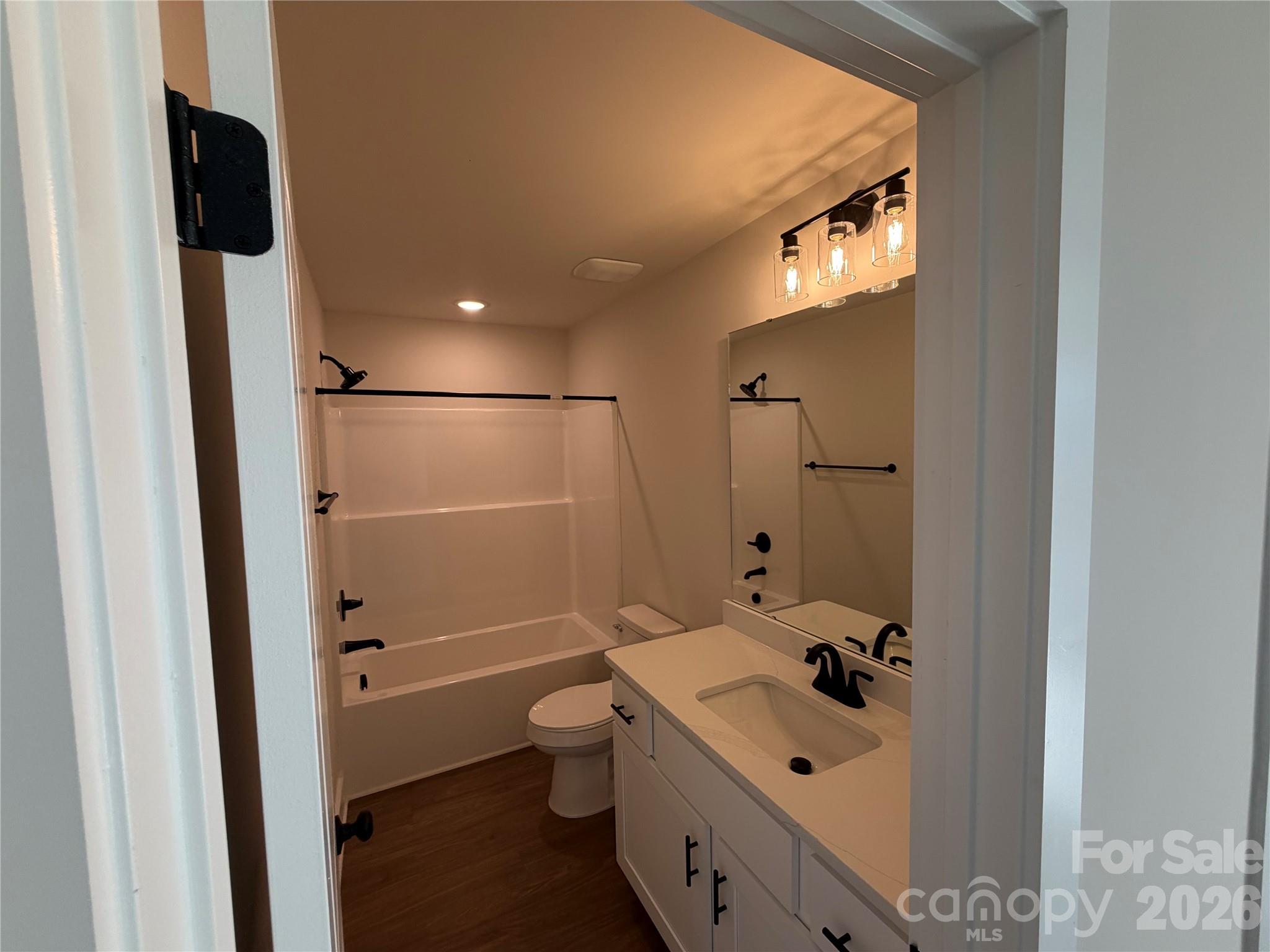 916 Blake Road Albemarle, NC 28001 - Photo 22 of 22 a bathroom with a double vanity sink a toilet and shower