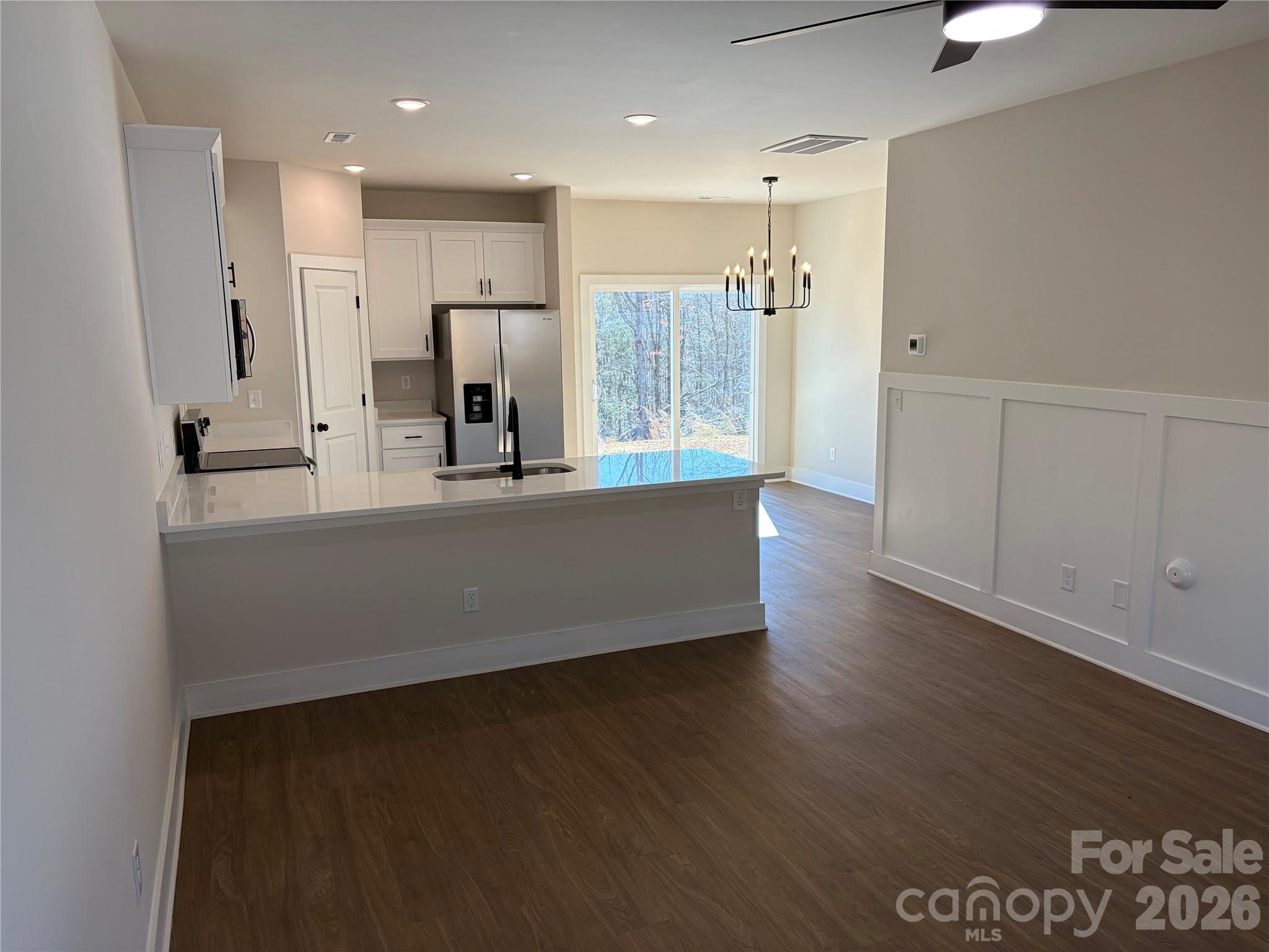916 Blake Road Albemarle, NC 28001 - Photo 4 of 22 a large kitchen with stainless steel appliances a large counter top a stove a sink and a refrigerator