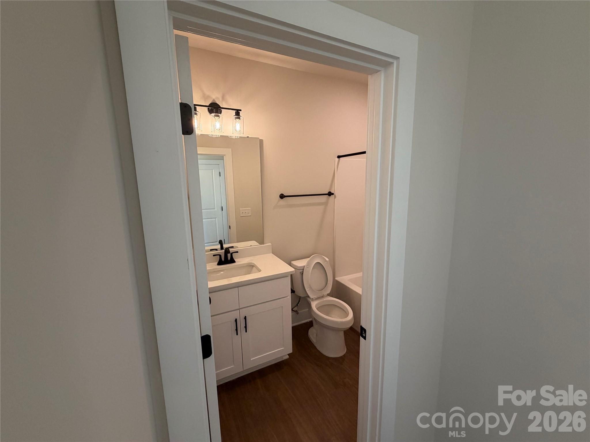 916 Blake Road Albemarle, NC 28001 - Photo 10 of 22 a bathroom with a sink a toilet and mirror