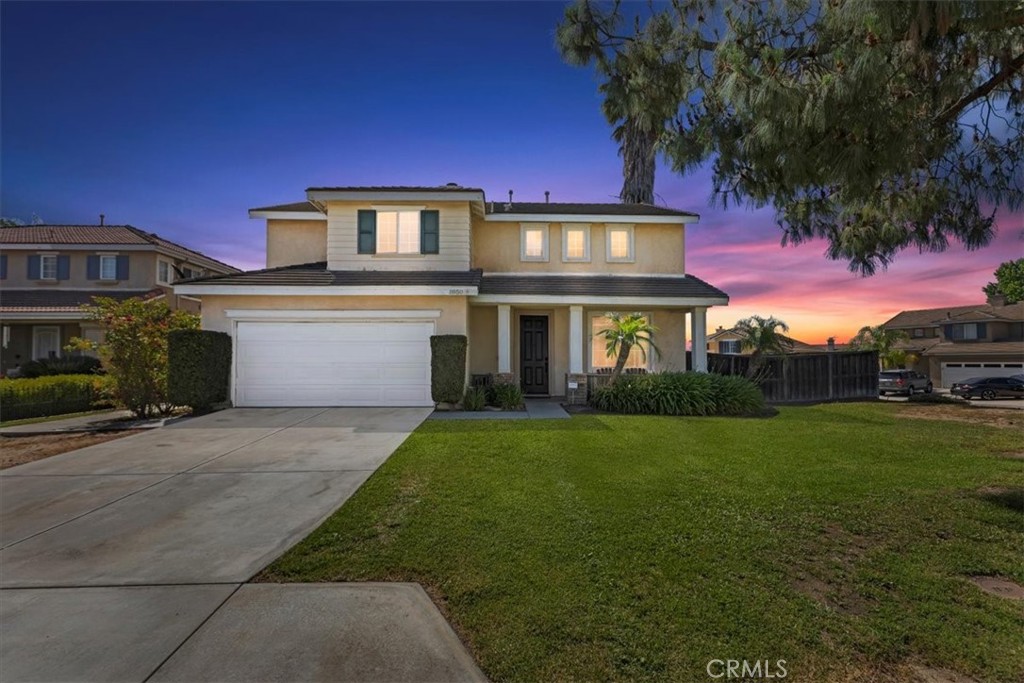 8950 Massena Street Riverside, CA 92508 - Photo 1 of 1 a front view of a house with a garden and yard