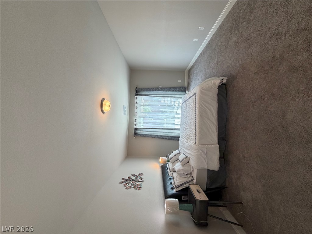 6385 Jackson Spring Road Las Vegas, NV 89118 - Photo 27 of 36 Well-appointed bedroom showcasing plush carpeting and ample natural light through window treatments.