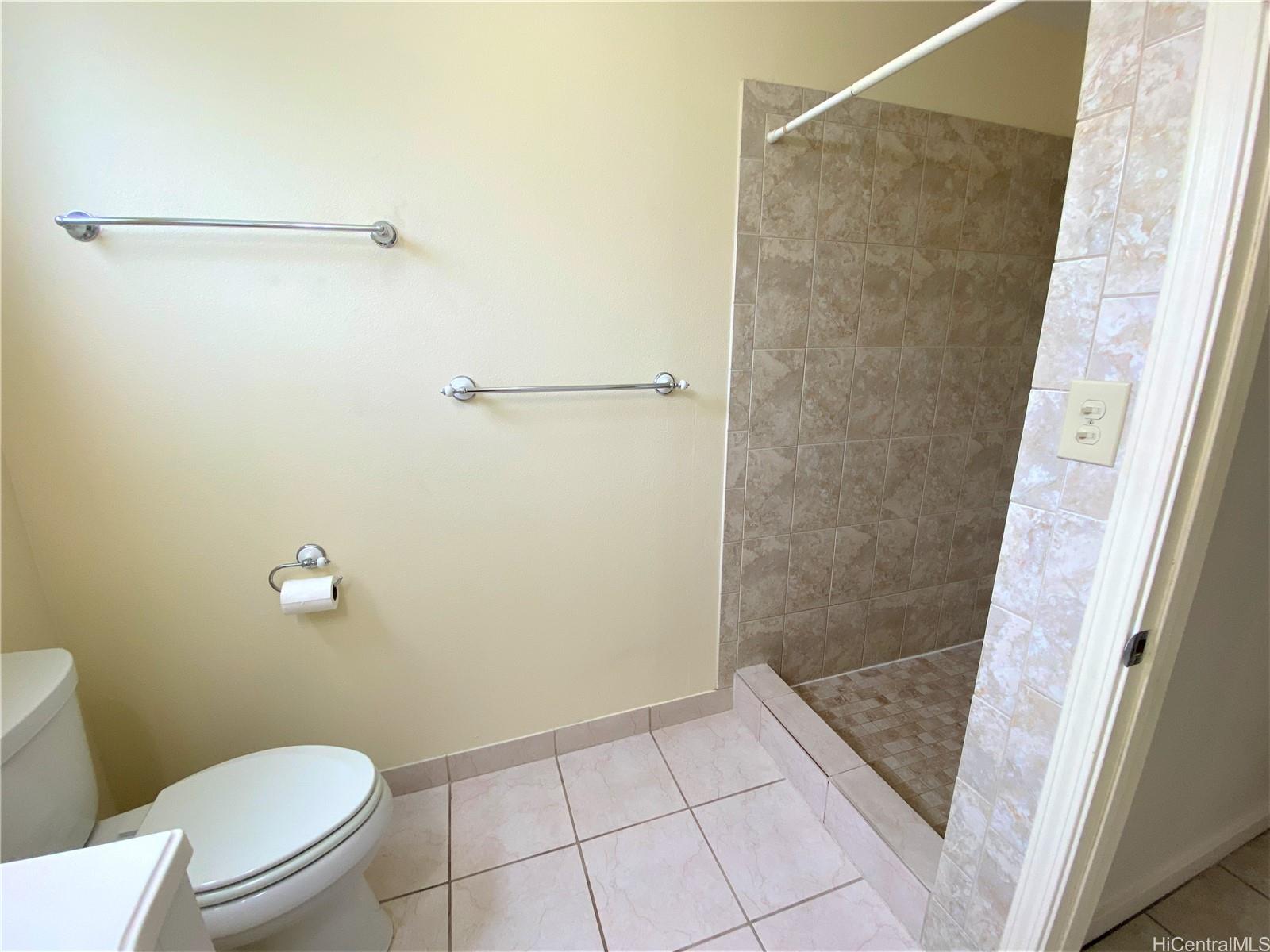 3339 Manoa Road, Unit 5 Honolulu, HI 96822 - Photo 11 of 13 a bathroom with a granite countertop shower and a toilet