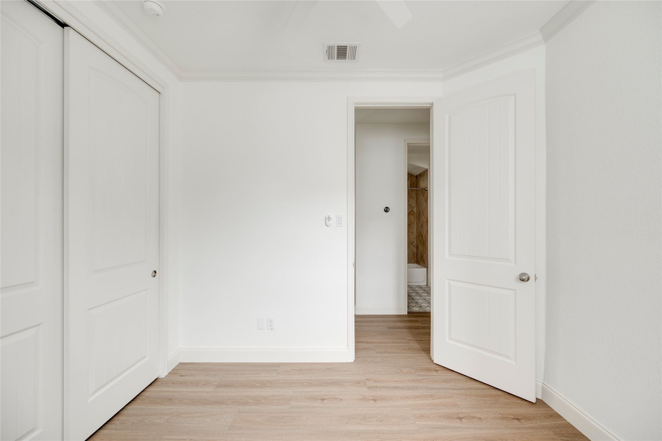 6008 Whipple Way Austin, TX 78745 - Photo 20 of 39 Naturally illuminated bedroom with durable laminate flooring and direct access to an adjacent bathroom.