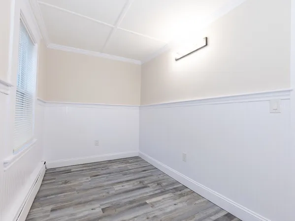 a view of a room with wooden floor