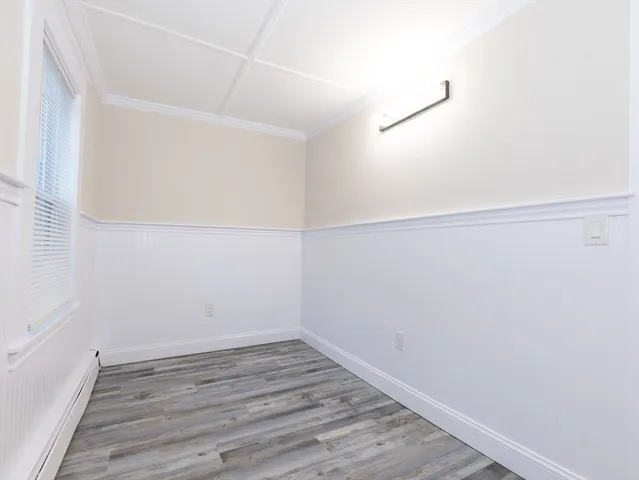 a view of a room with wooden floor