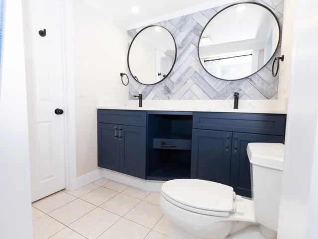 a bathroom with a toilet a sink and a mirror