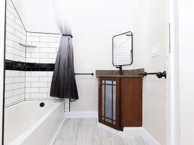 a bathroom with a sink a toilet and bathtub