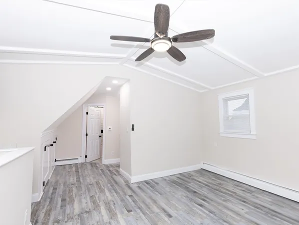 a view of a room with wooden floor