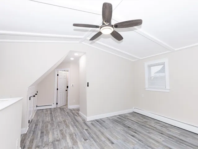 a view of a room with wooden floor