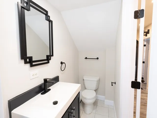 a bathroom with a sink toilet and mirror