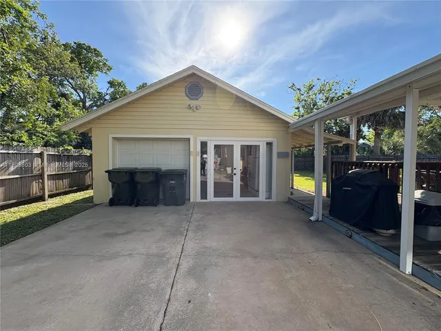 a front view of a house with a garden and yard
