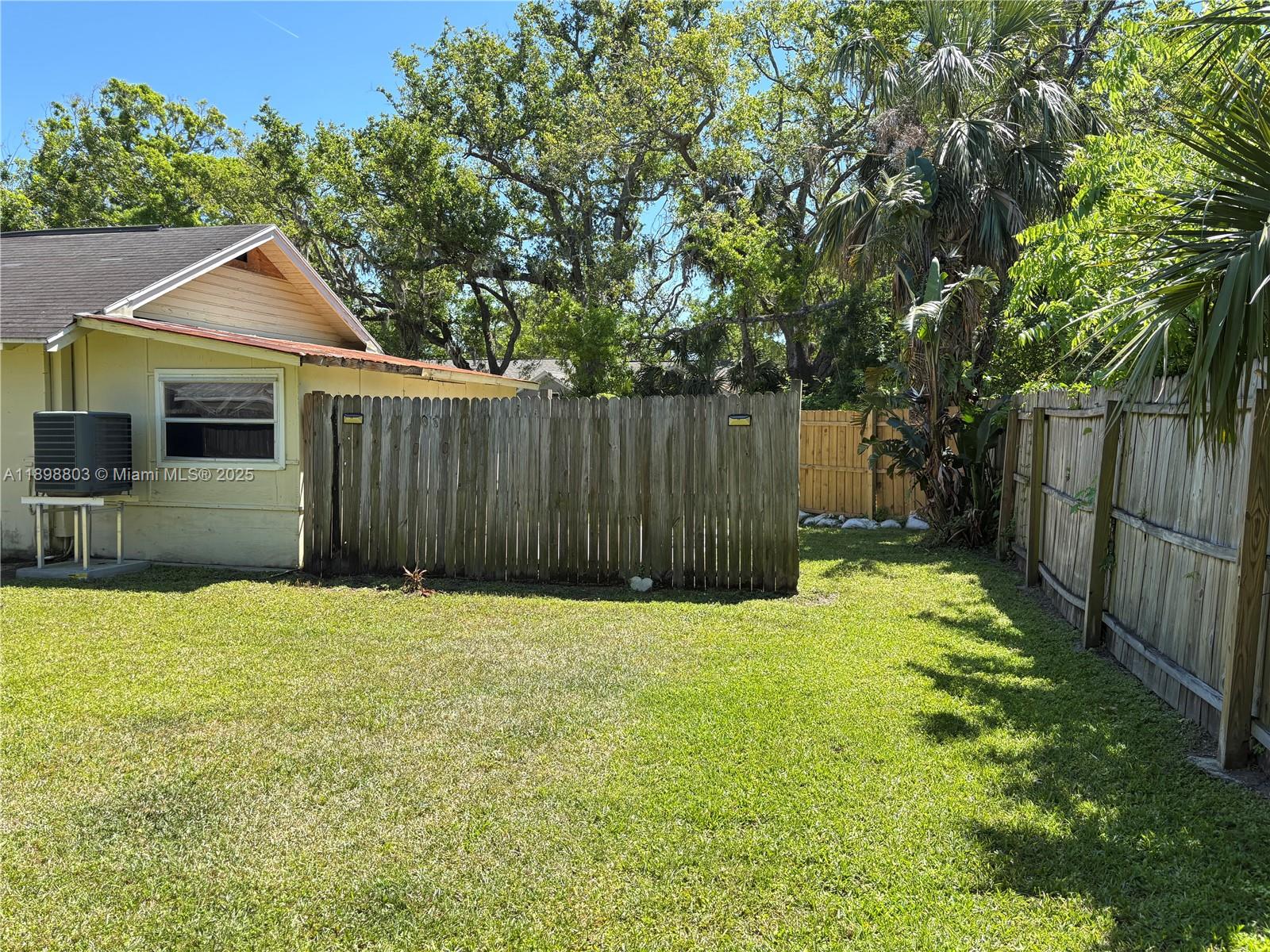 830 South Beach Street, Unit 2 Daytona Beach, FL 32114 - Photo 4 of 11 a front view of a house with a yard