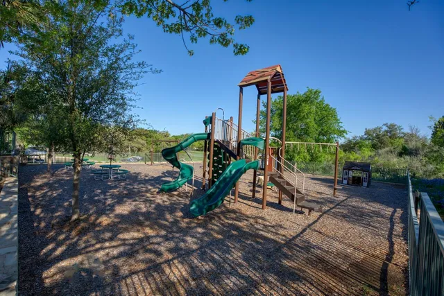 a view of a park with large trees