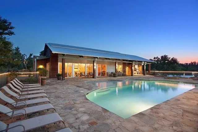 a view of a swimming pool with lounge chairs