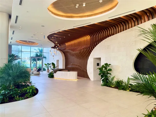 a lobby with furniture and flowers