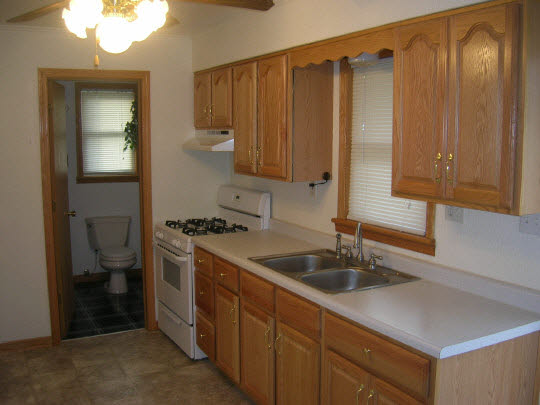 425 Barry Road Rockford, IL 61109 - Photo 3 of 5 a kitchen with stainless steel appliances granite countertop a sink and a refrigerator