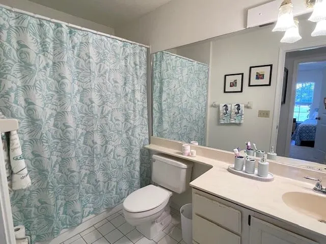 a bathroom with a granite countertop sink a toilet and a mirror