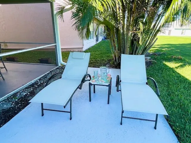 a view of a backyard with sitting area