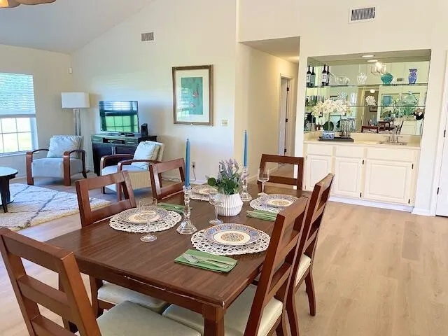 a view of a dining room with furniture and wooden floor