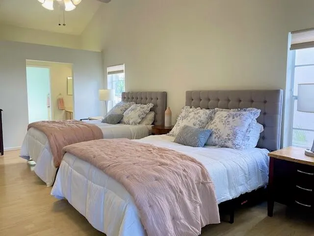 a bedroom with two beds and a lamp