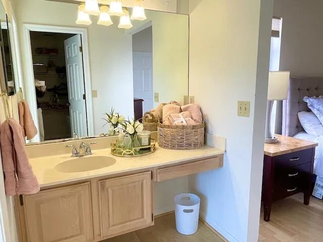 a bathroom with a granite countertop sink and a mirror