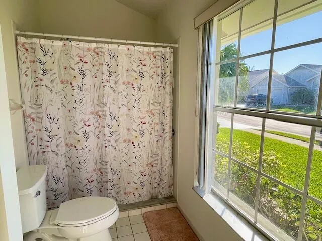 a white toilet sitting next to a window