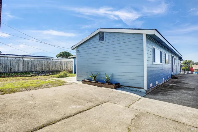 a yellow house with yard in front of it