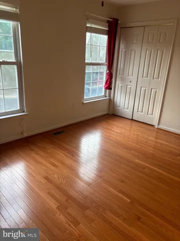 a view of a room with wooden floor and staircase