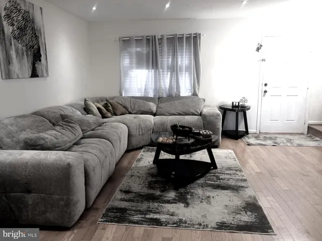 a living room with furniture and a rug