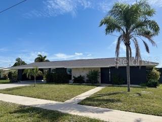 181 Beeney Road Southeast Port Charlotte, FL 33952 - Photo 1 of 47 a front view of house with a garden