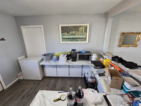 a bedroom with wooden floor and closet